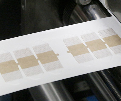 Multiple Layer Laminations for Adhesive Material